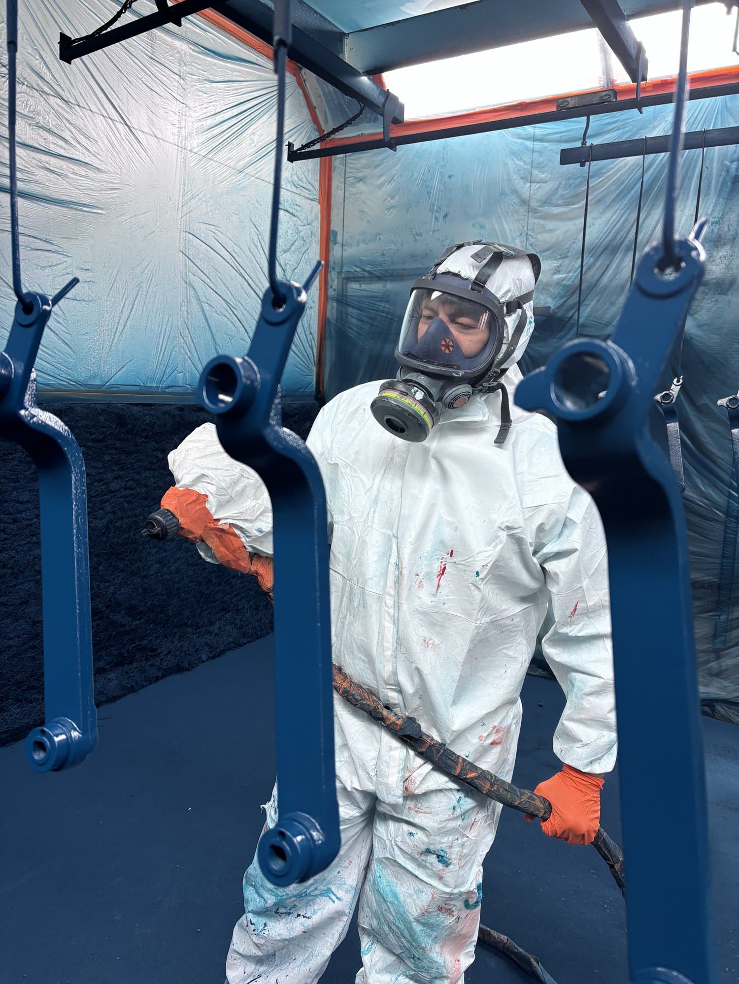 EdgeTech industrial painting specialist in full respirator and coveralls